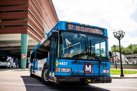 A MetroBus pulls out of the Clayton transit center. The operator can be seen through the windshield.