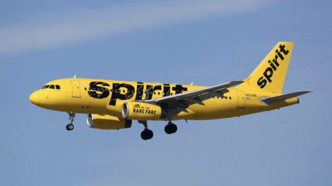 Image of a Spirit Airlines yellow plane flying in the air
