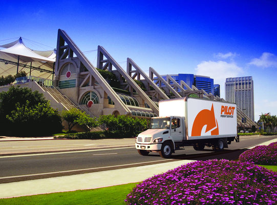 Photo of a Pilot Freight Service truck in front of a building.