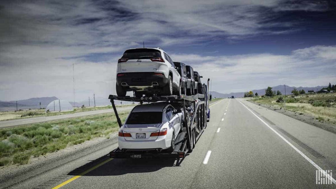 A rig truck with cars loaded onto it.