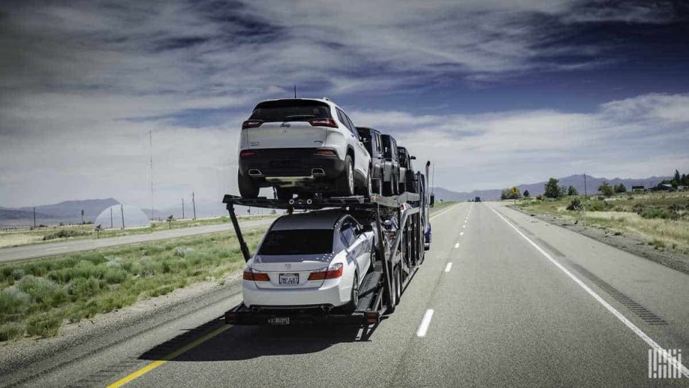 A rig truck with cars loaded onto it.