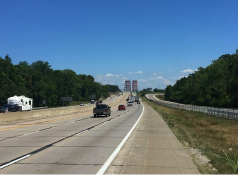 Photo showing a highway with cars and trucks driving on it