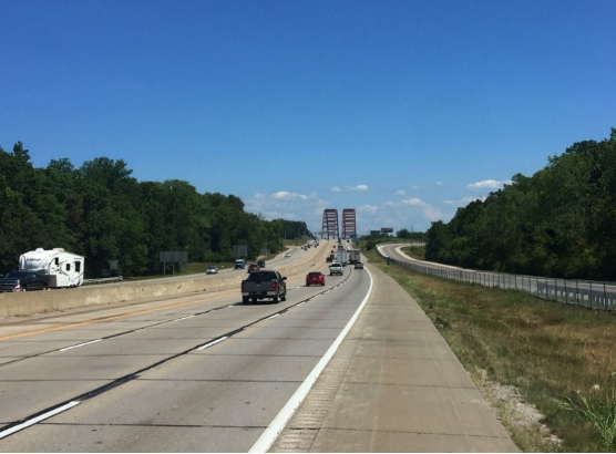 Photo showing a highway with cars and trucks driving on it