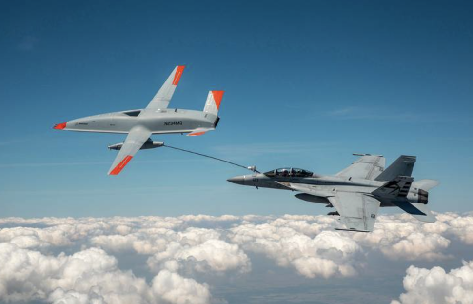 An unmanned MQ-25 aircraft, left, delivers fuel to an U.S. Navy F/A-18 Super Hornet jet fighter in June during an aerial test that originated at MidAmerica St. Louis Airport in Mascoutah.