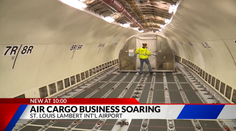 A worker removes cargo from the fuselage of a plane at St. Louis-Lambert International Airport.