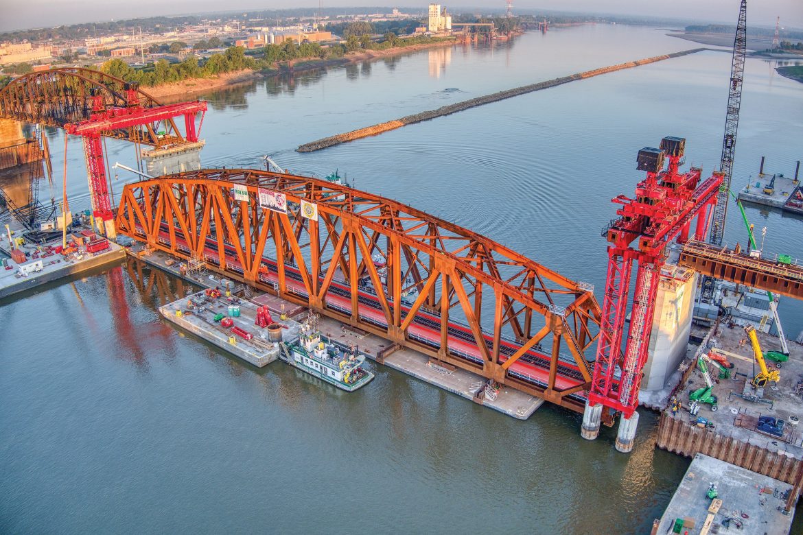 A section of the Merchants Bridge being put in place by construction crews over the Mississippi River.