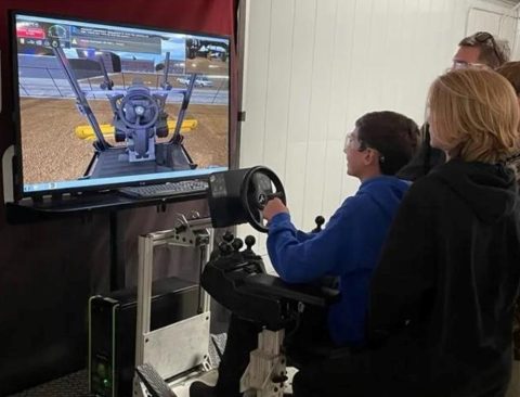 A high school student trains on a simulator