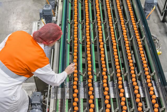 Refresco employee on the product inspection line.