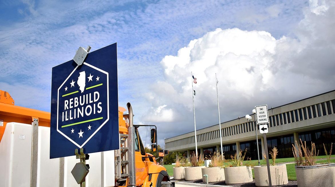 Rebuild Illinois sign in front of dump truck.